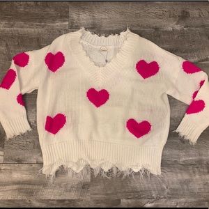 white sweater with pink hearts